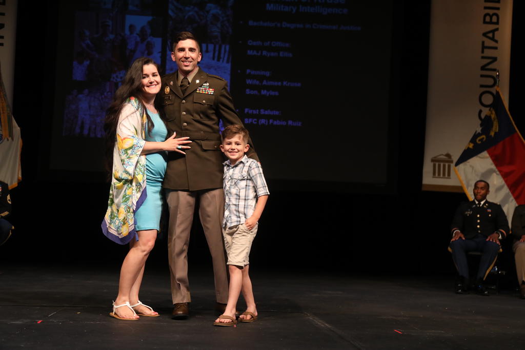 Brian Kruse with his wife, Aimee, a UNCP alumnae, and their son at the US Army Commissioning Ceremony