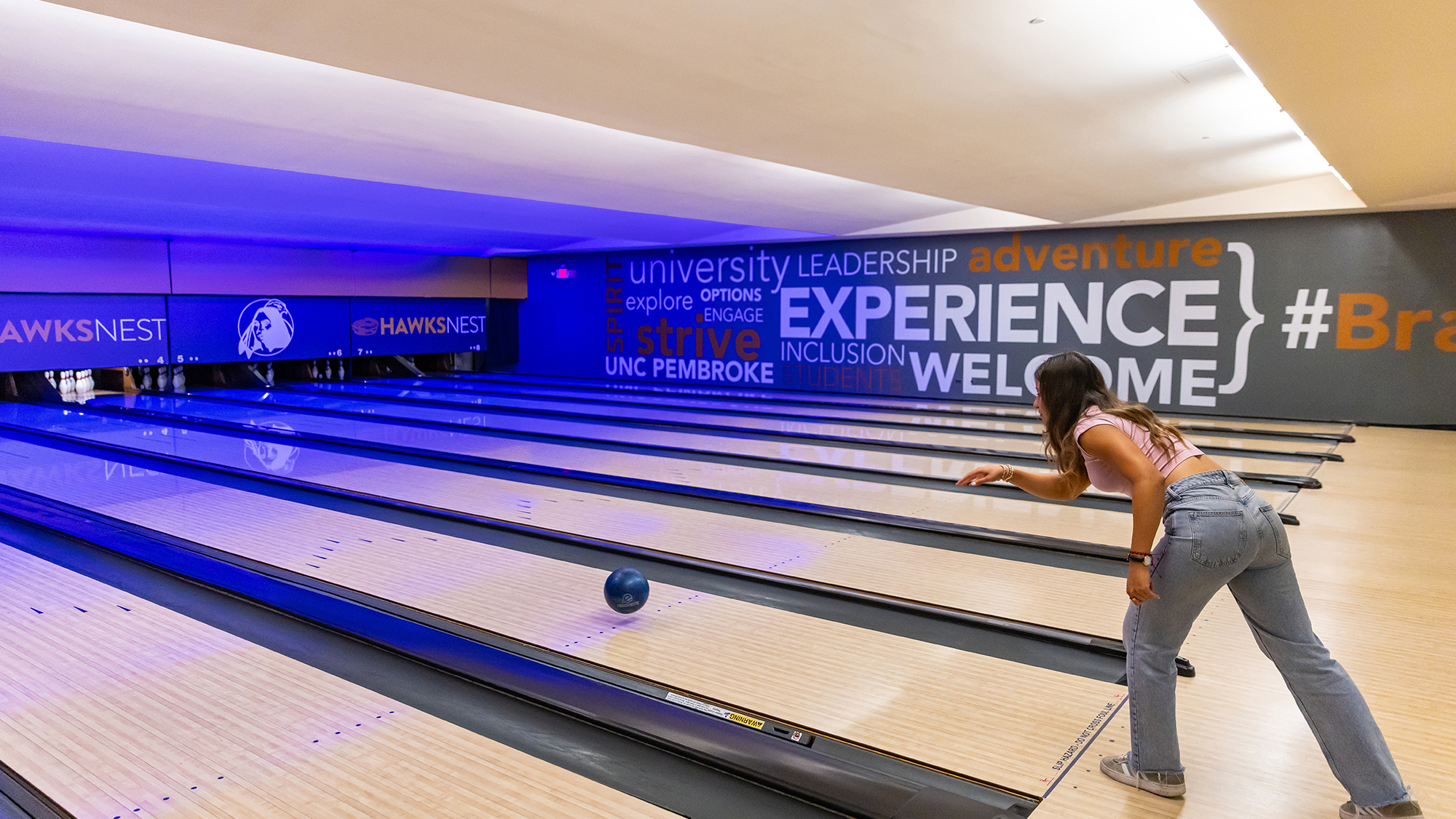 female student bowling at UNC Pembroke
