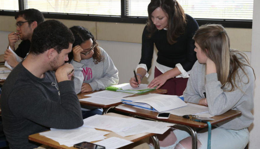 Dr. Virginia Garnett works with students in her composition class.