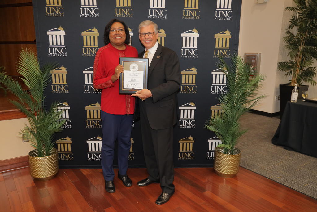 Chancellor Cummings presents Becky Thompson with a certificate recognizing her 35 years of service
