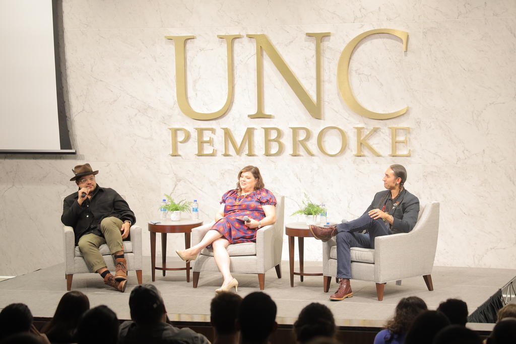 Sterlin Harjo, left, and Tatanka Means (far right), speak during a fireside chat with Nancy Fields at James A. Hall on Tuesday, November 8.