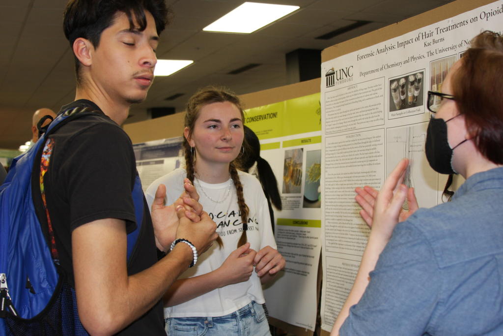 Kae Burns (right) discusses her research
