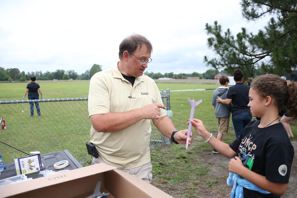 Dr. Steven Singletary assist a camper during the annual Cummings Aerospace Engineering Camp
