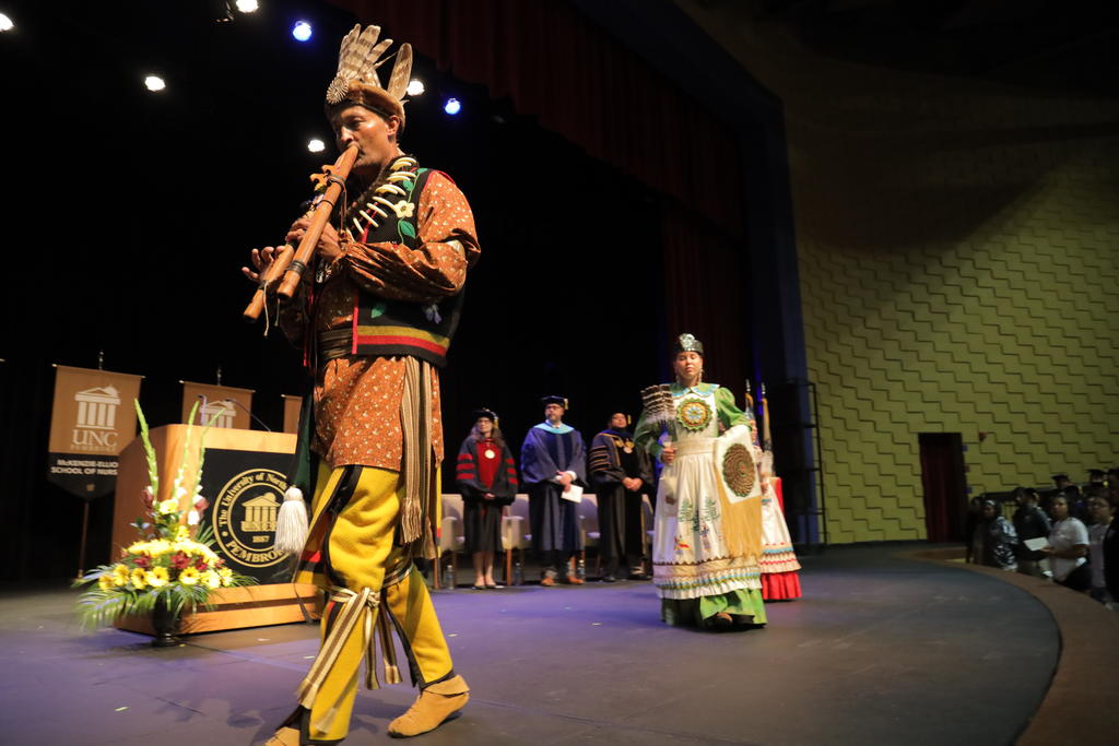 Lumbee flutist John Oxendine leads the Lumbee Ambassadors during the processional at Convocation at UNC Pembroke on August 14, 2023