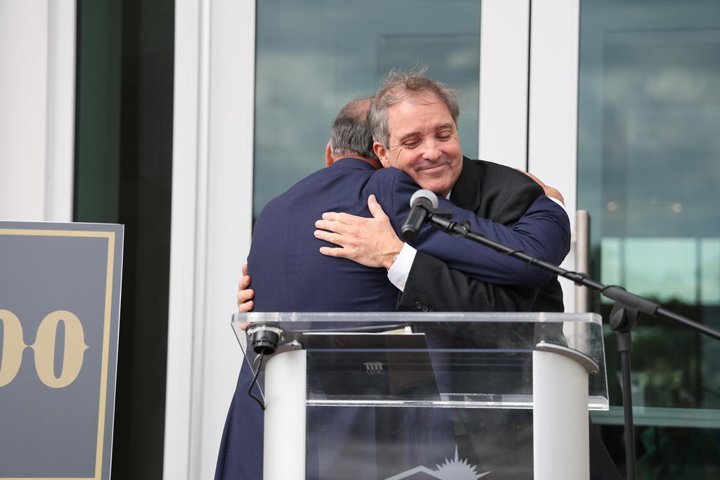 Greg Bacot hugs Chancellor Robin G. Cummings, MD.