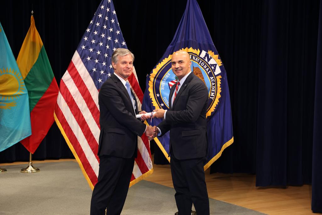 UNCP alumnus Capt. Scottie Chavis (right) pictured with FBI Director Christopher Wray at the FBI National Academy graduation ceremony in Quantico, Virginia