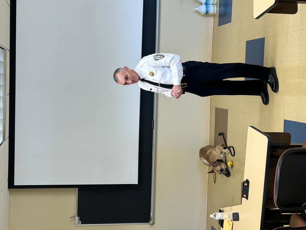 Hope Mills Chief of Police Steve Dollinger and K9 Police dog, Kaeden visit with CJ Lecturer Jesse McQueen and the Criminal Justice Club.
