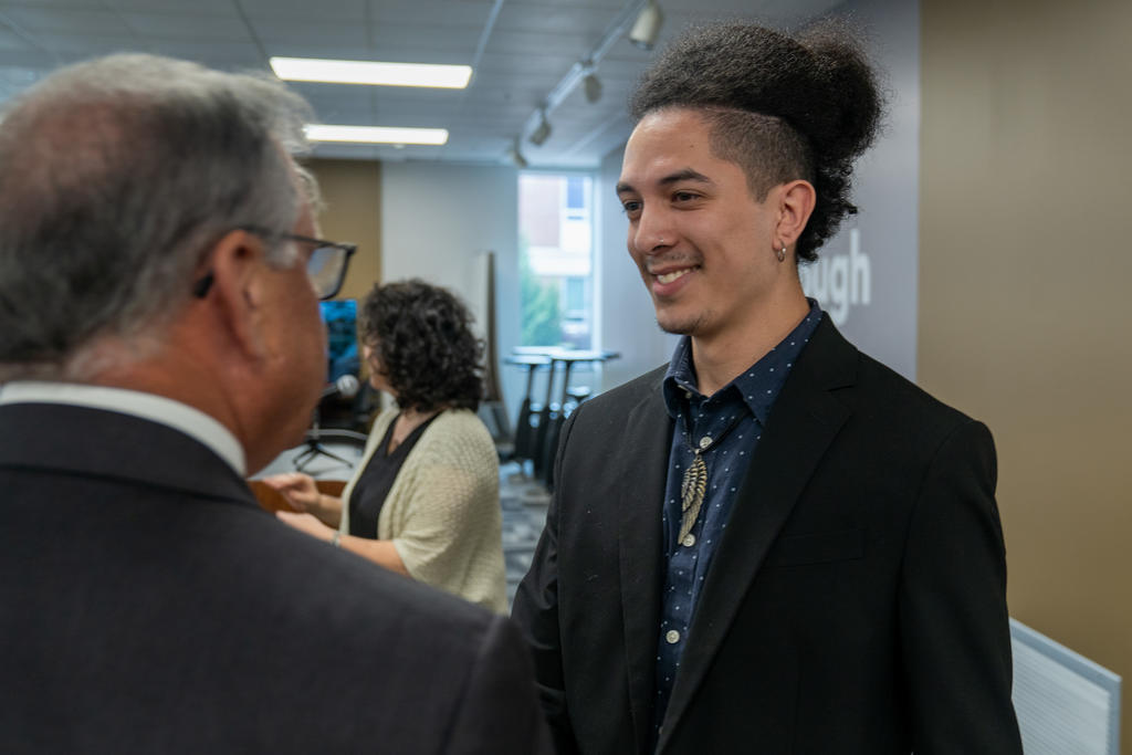 UNCP junior Ahelayus Oxouzidis engages with Chancellor Robin Gary Cummings