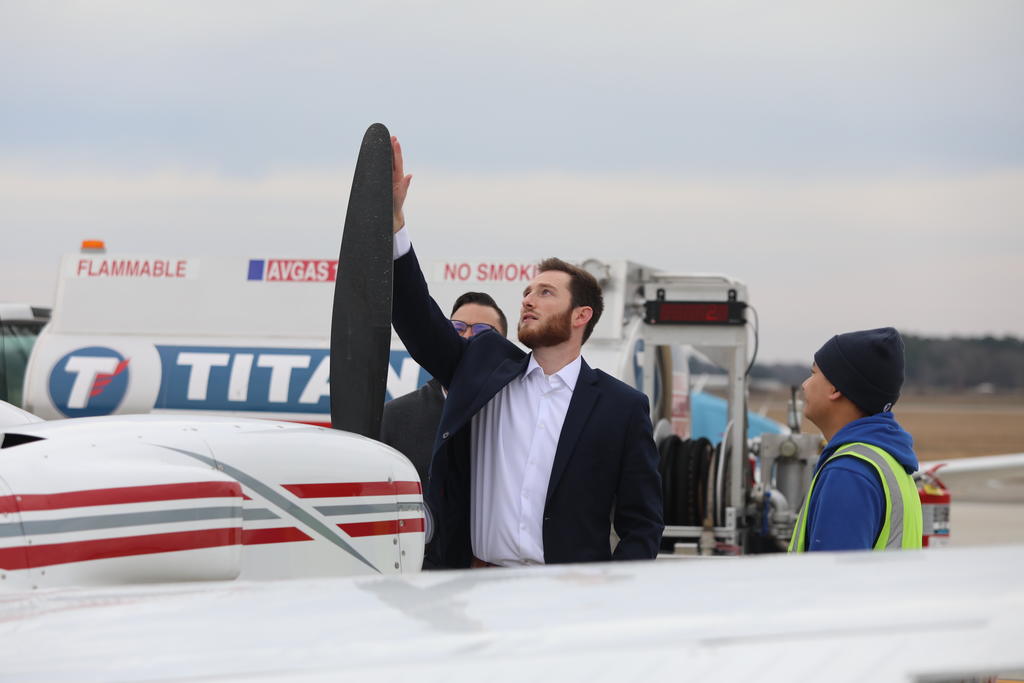 Seth Hatchell, examines a plane propeller at the Laurinburg-Maxton Airport where he serves as executive director