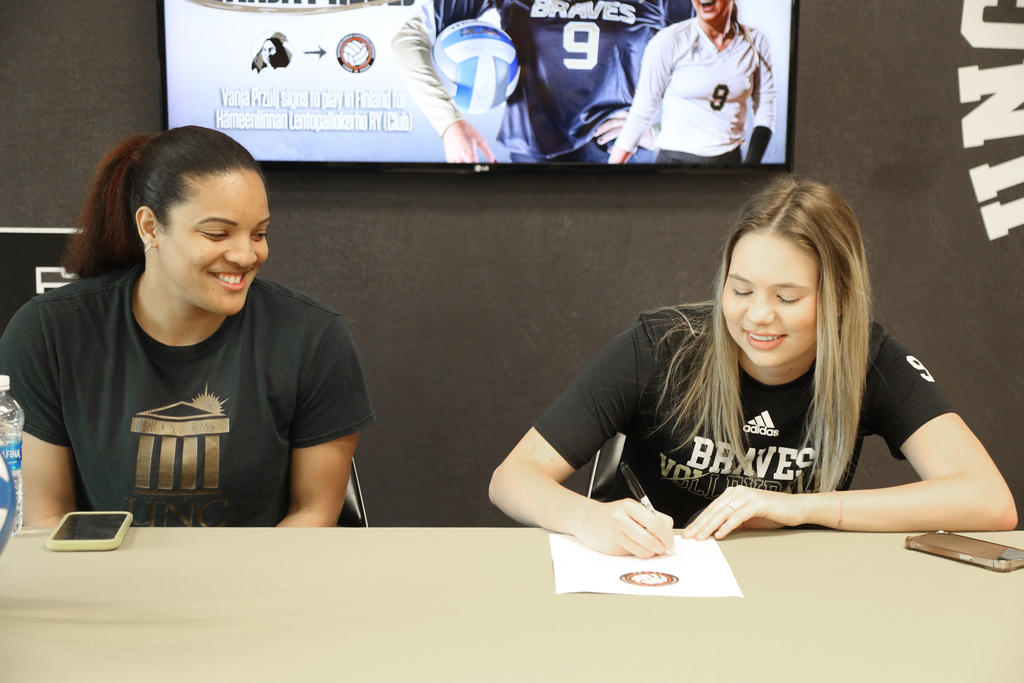 All-American volleyball standout Vanja Przulj (right) signs a pro contract with Hämeenlinnan Lentopallokerho Ry in Finland. Head coach Jaleesa Harper (left) and several teammates also attended the signing event on Friday, April 20, 2024.