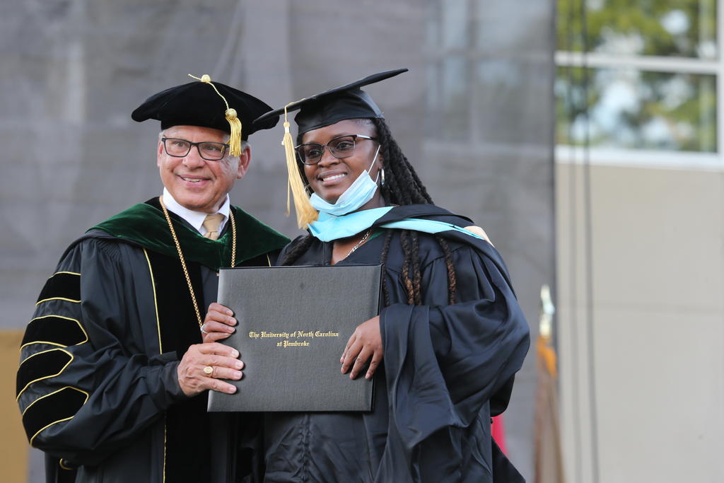Alexius Fields poses with Chancellor Robin Gary Cummings during The Graduate School ceremony on May 3, 2024