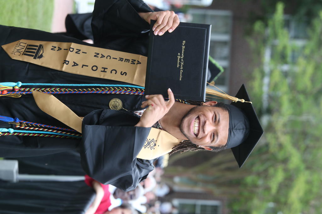 Alaqua Jacobs shows of his degree after crossing the stage on Saturday, May 3 at Spring Commencement