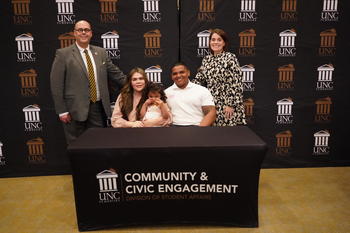 Taley Hunt, her husband, Jordan, and their daughter, Reese, is joined at the gift signing ceremony with Dr. Jeff Howard, vice chancellor for Student Affairs, and Dr. Christie Poteet, associate dean of Students