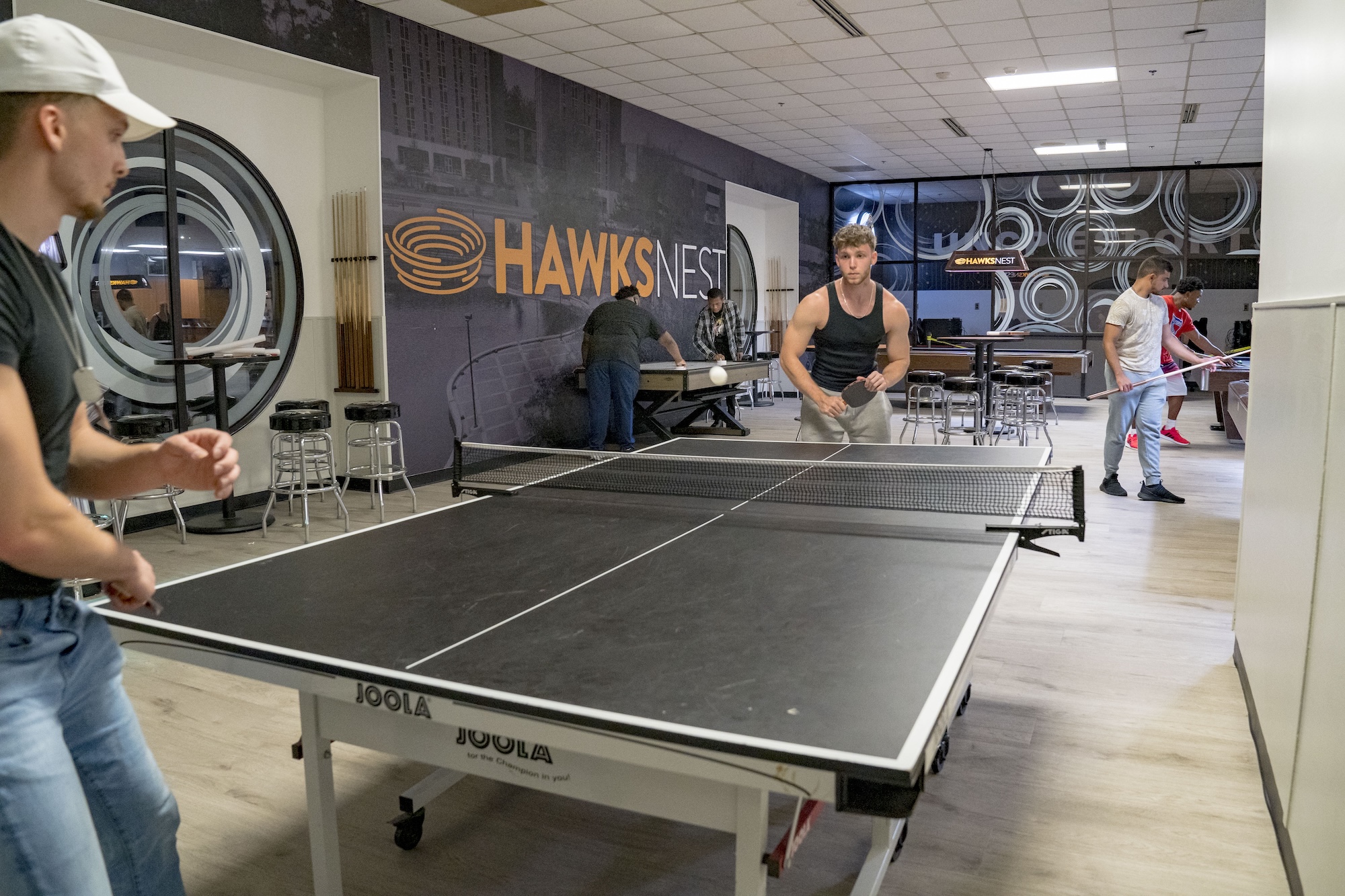 Guys playing ping pong Hawks Nest UNC Pembroke