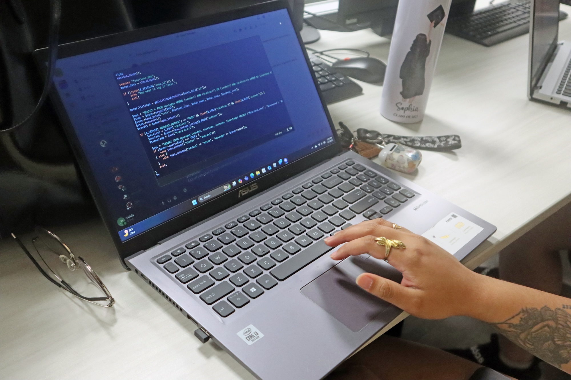 student coding on laptop