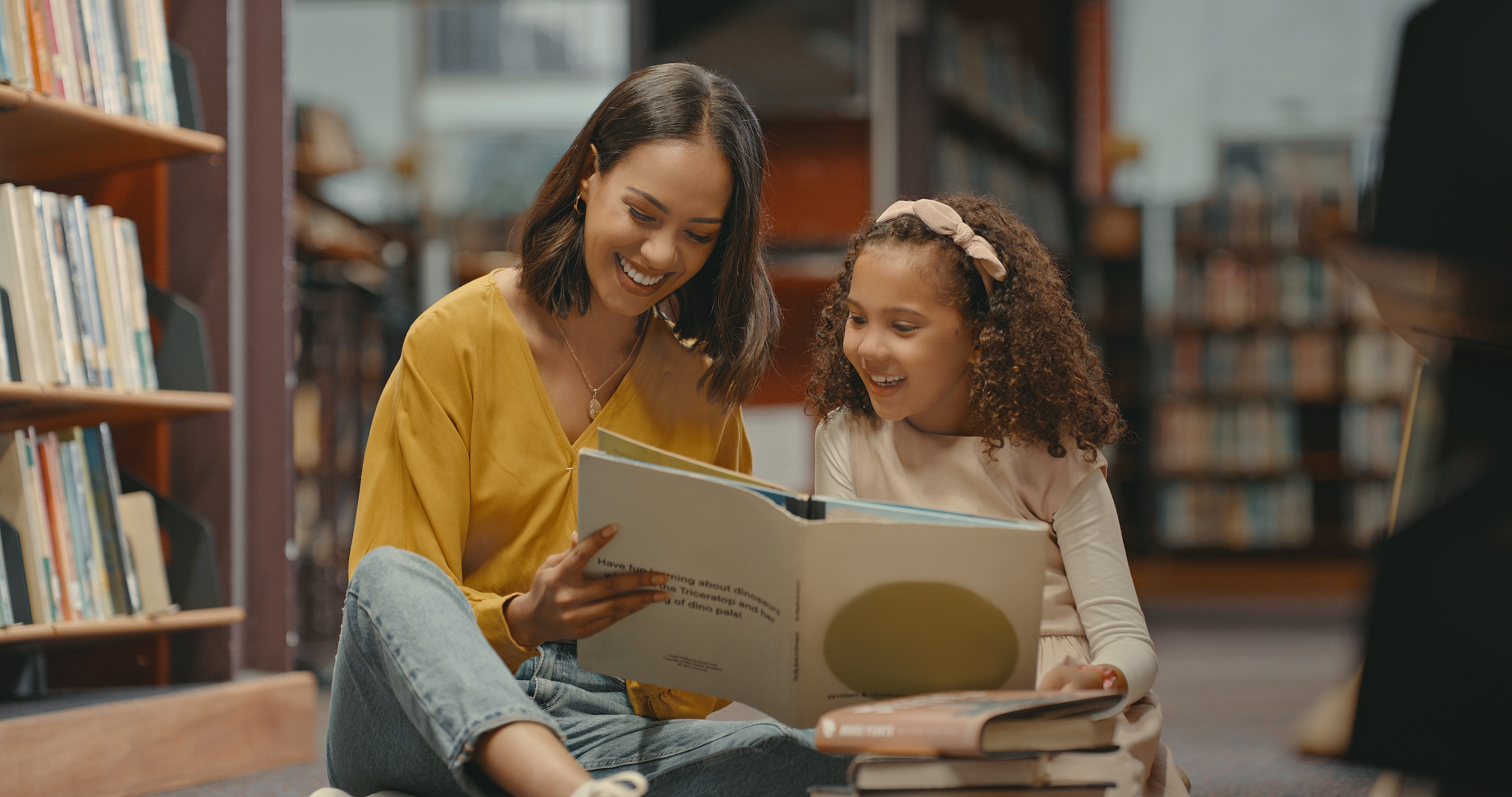 woman reading to student in library