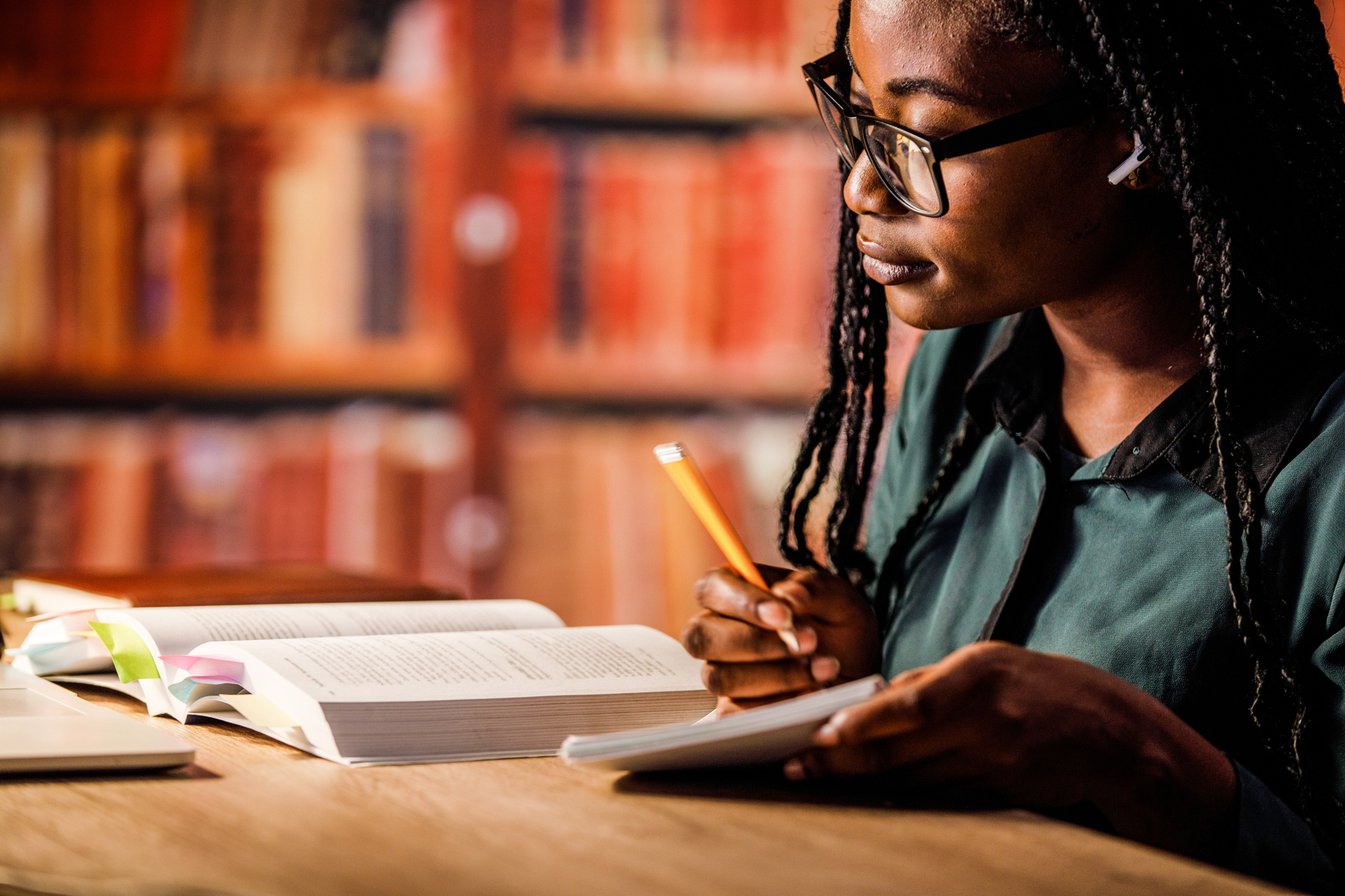 African American woman studying in a library