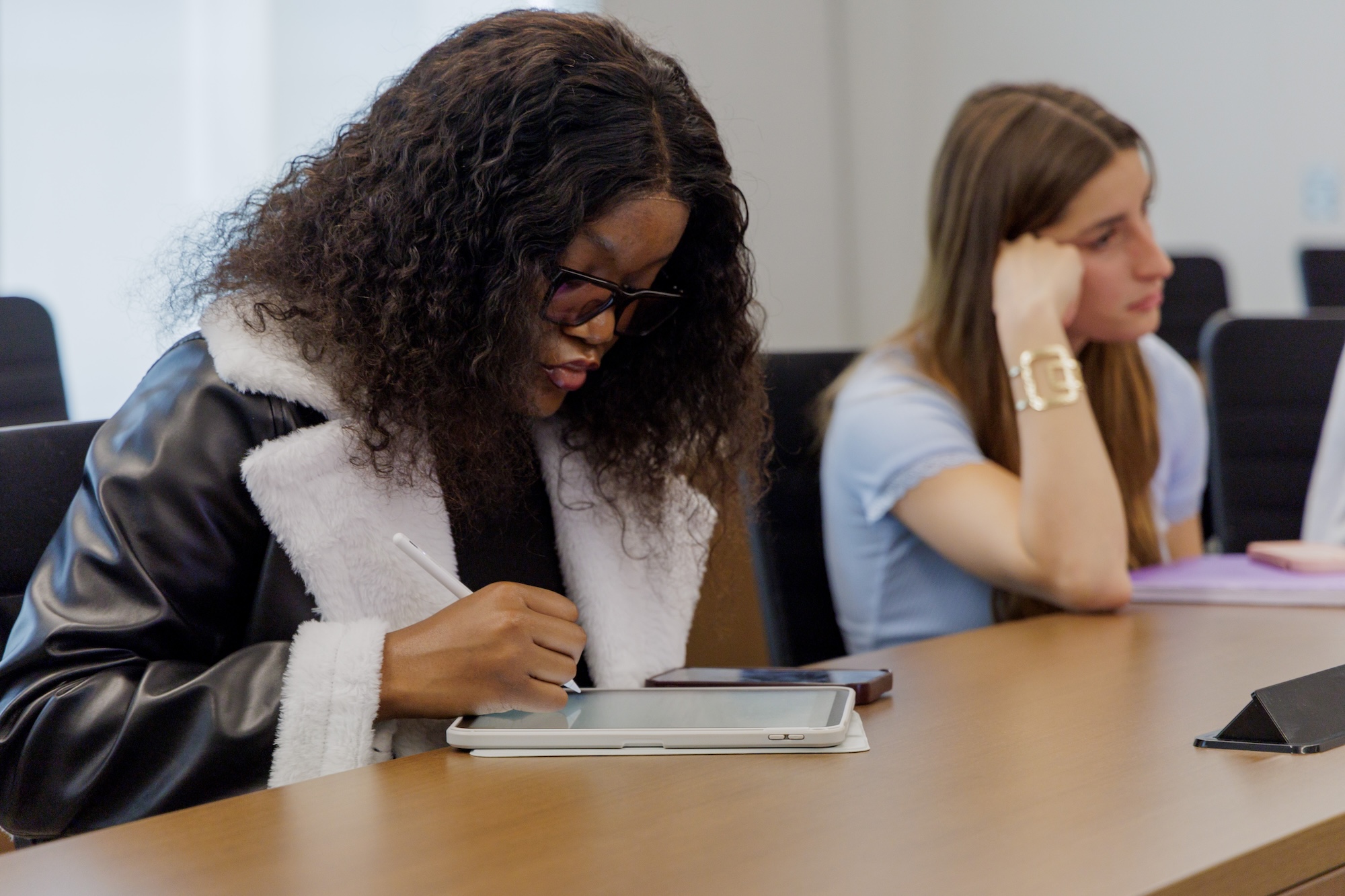 UNCP international student taking notes on an iPad