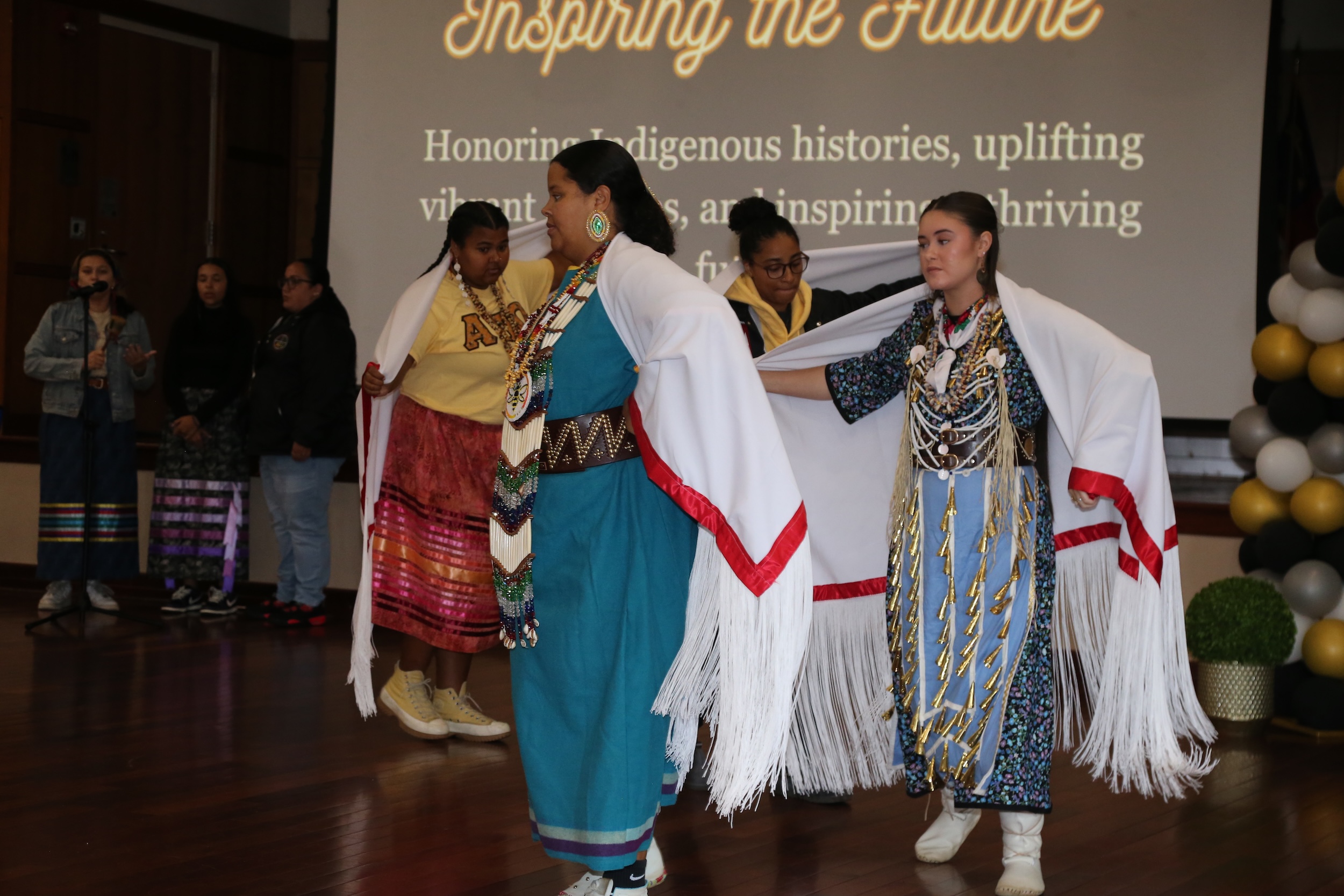 Members of Alpha Pi Omega perform a traditional swan dance during an Indigenous Peoples