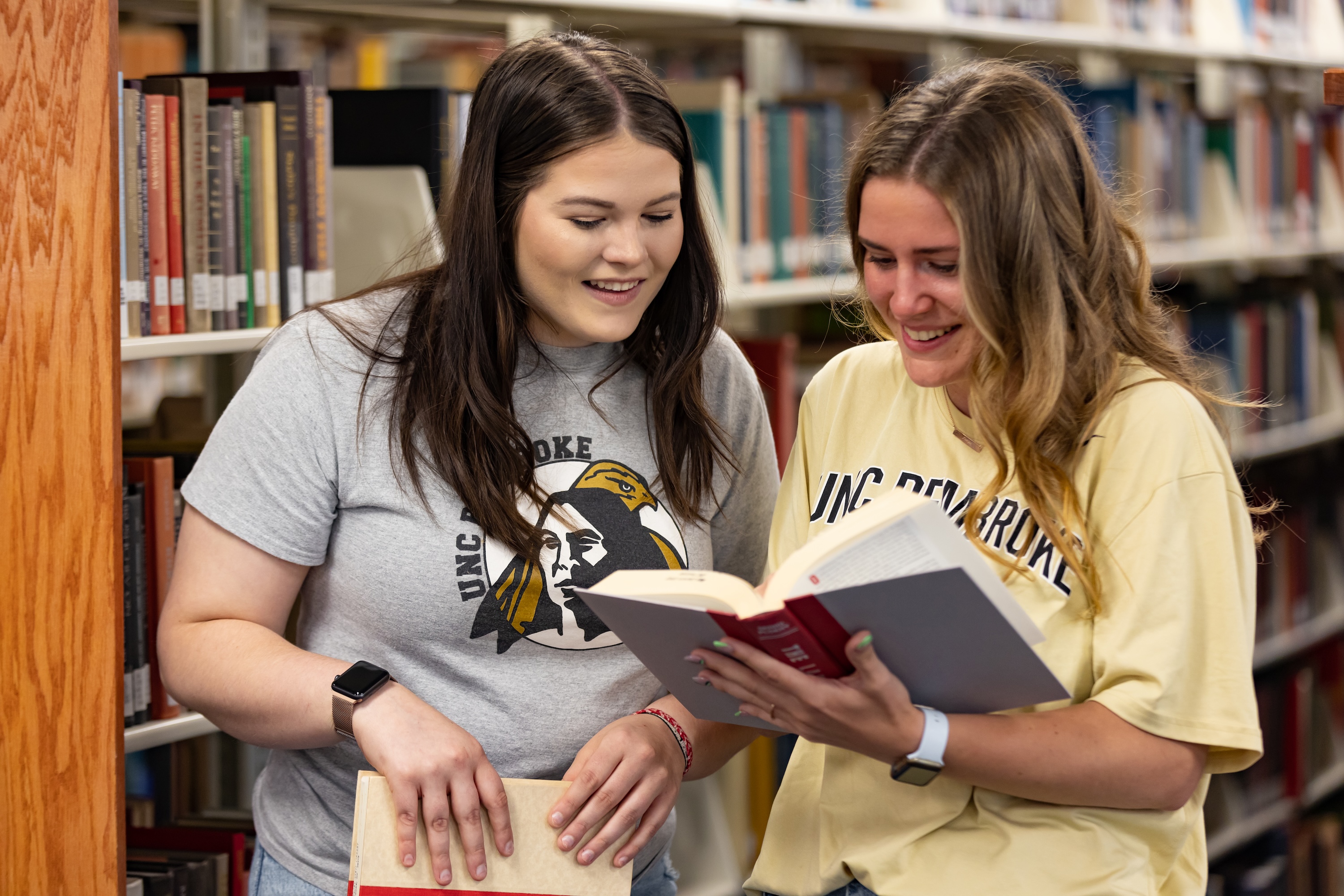 UNCP female students in Mary Livermore Library reading books