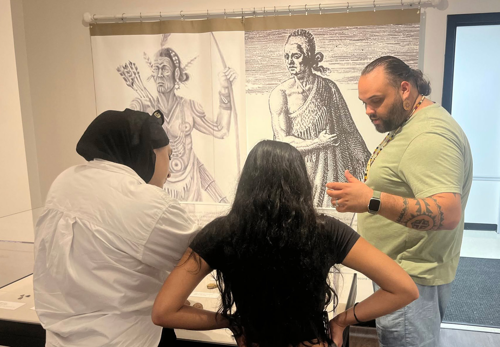 Students observe a display of artifacts.