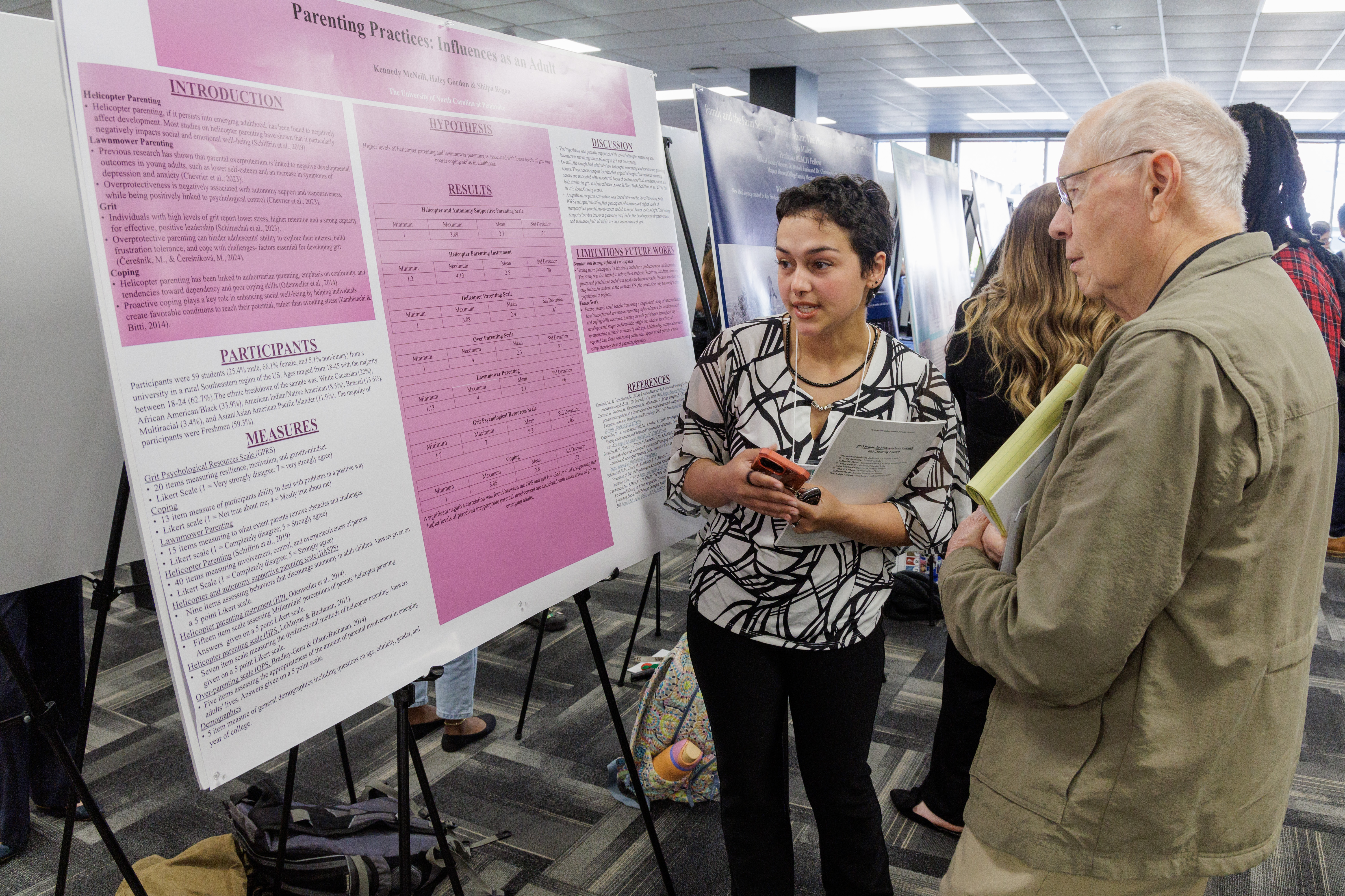 female UNCP psychology student doing poster presentation at PURC symposium