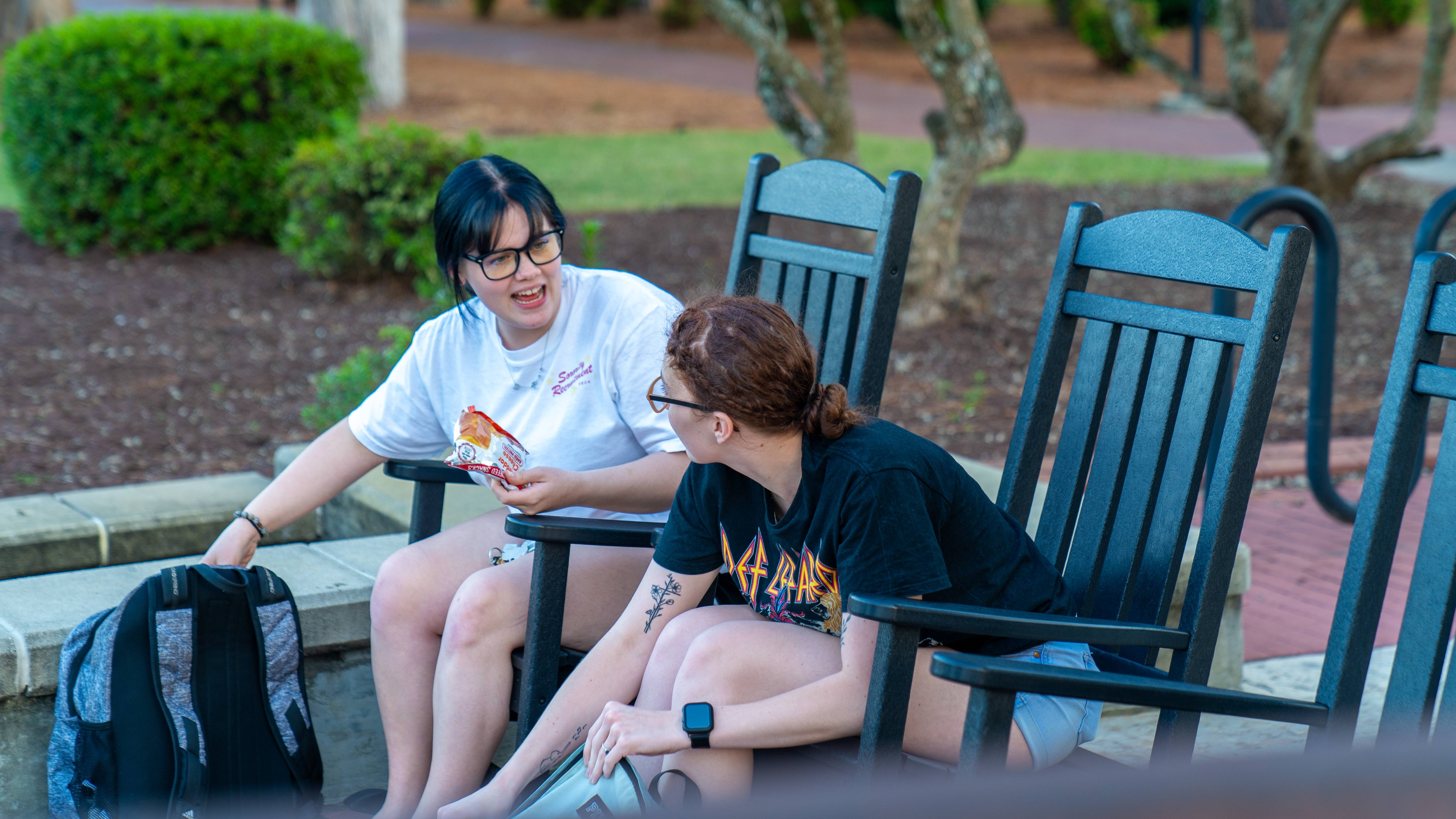 Students in rocking chairs on campus