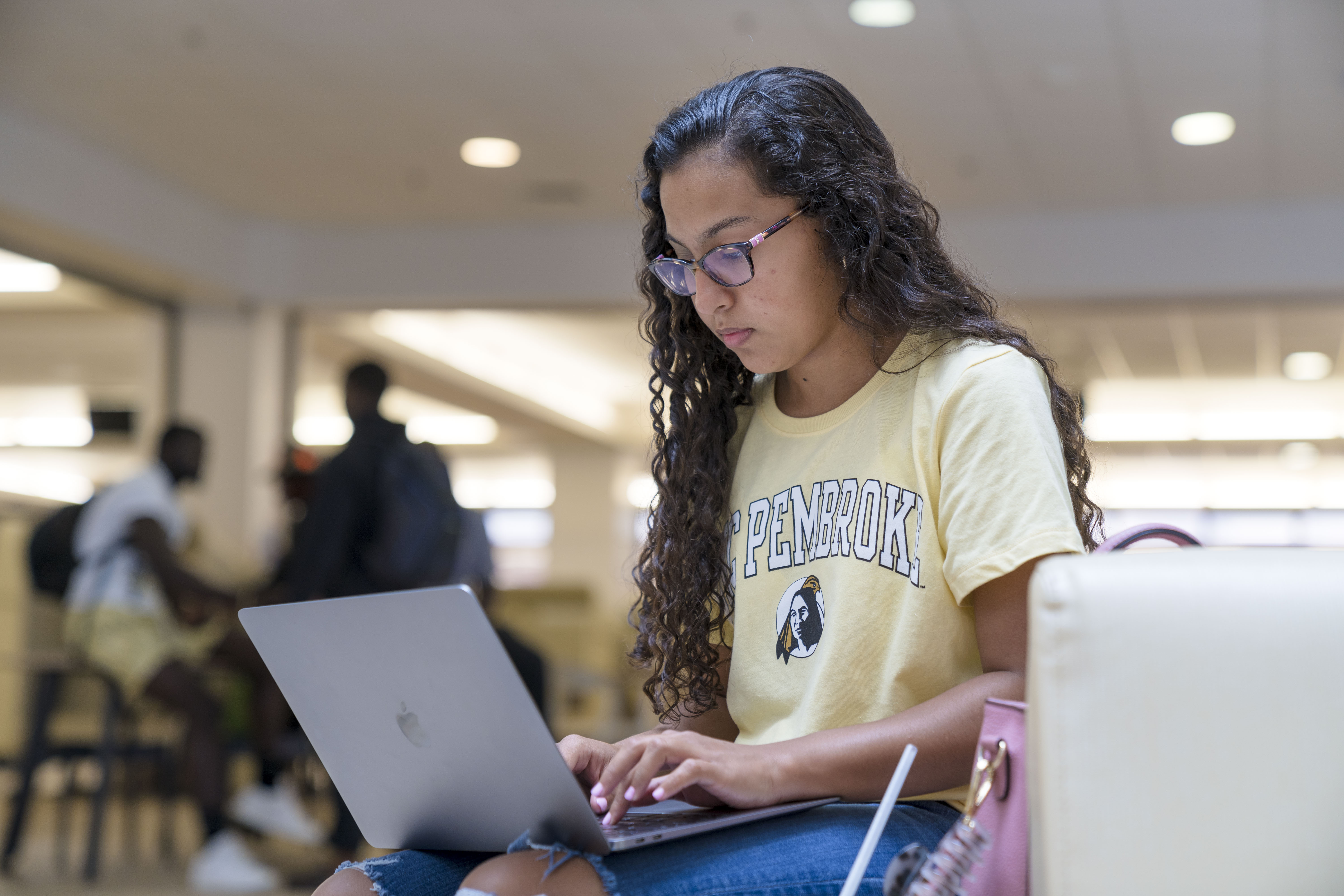 UNCP student on a laptop in the Jame B. Chavis Student Center