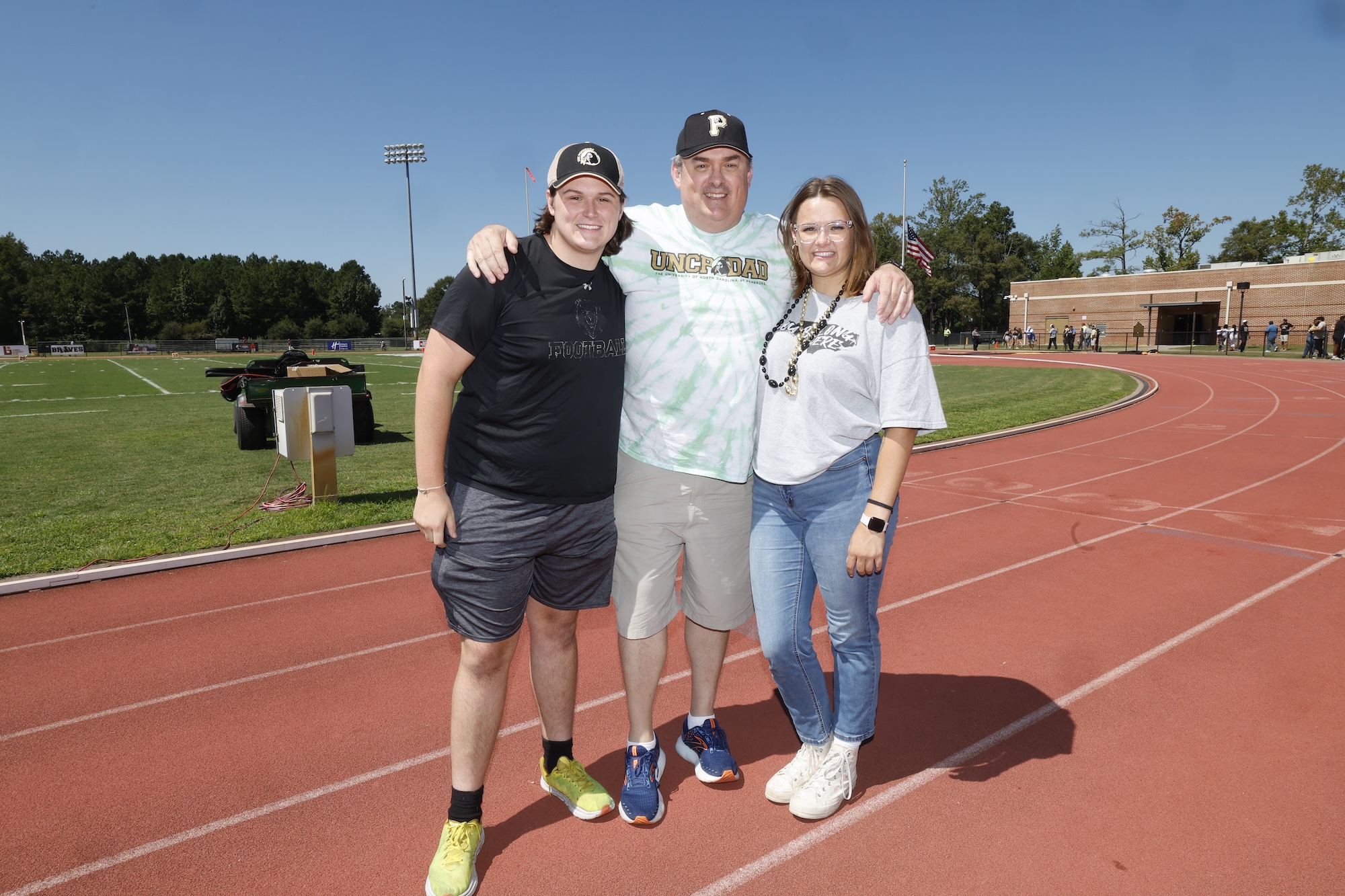 UNCP male student with parents on track
