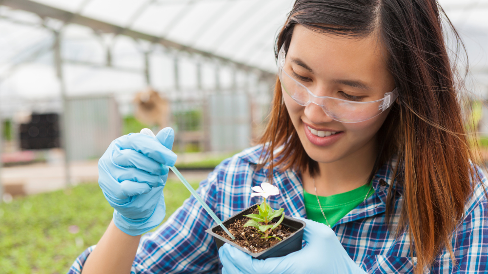 girl holding plant and dropper