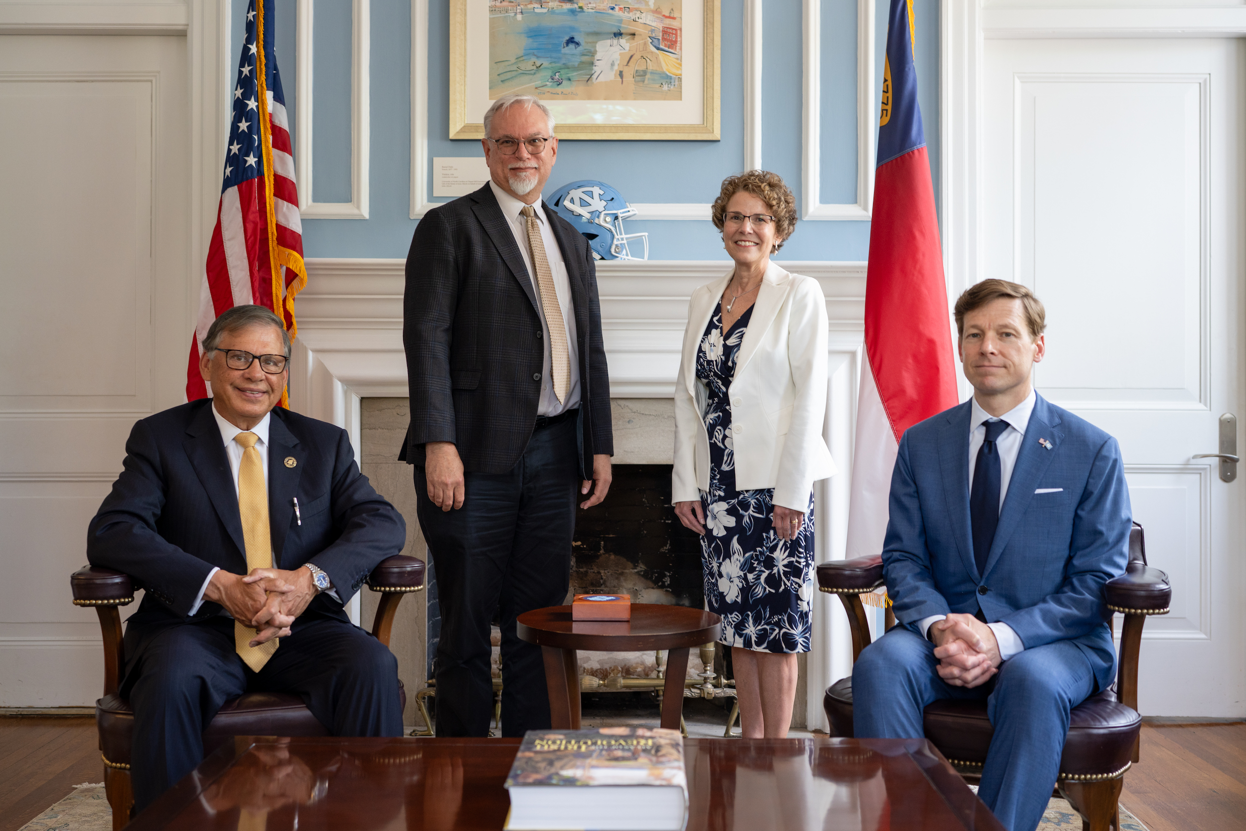 UNCP Chancellor Robin Gary Cummings (left) and UNC Chancellor Lee H. Roberts join Dean Richard Gay (standing) and Dean Janet Guthmiller at a signing event establishing the Early Assurance Admission initiative