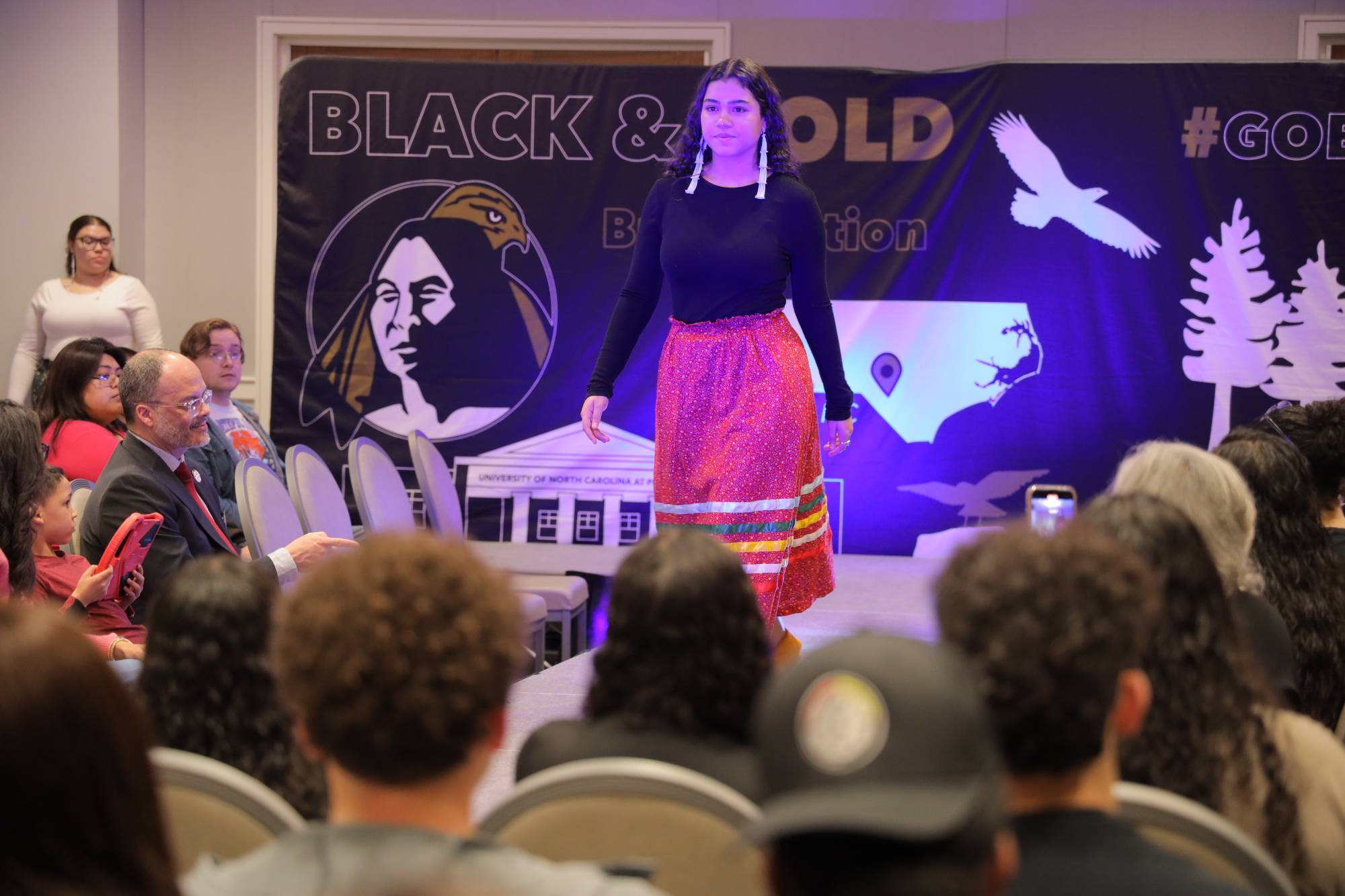 Student model Braydann Revels on the runway at the Ribbon Work Fashion Show