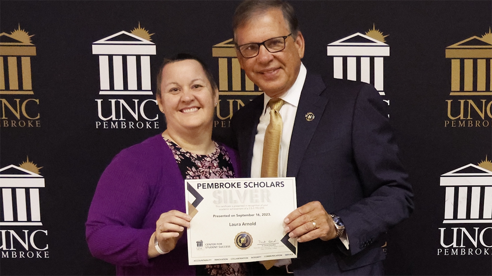 Chancellor Robin Gary Cummings presents Laura Arnold with the Silver Scholar Award at the 7th Annual Pembroke Scholars Achievement Ceremony.
