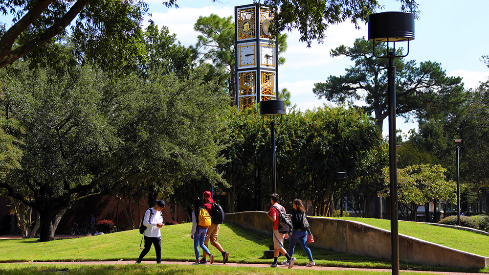 The campus of UNC Pembroke with a clocktower in the background.