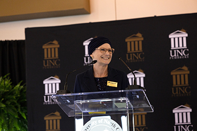 Dr. Diana Prusank speaking at the podium