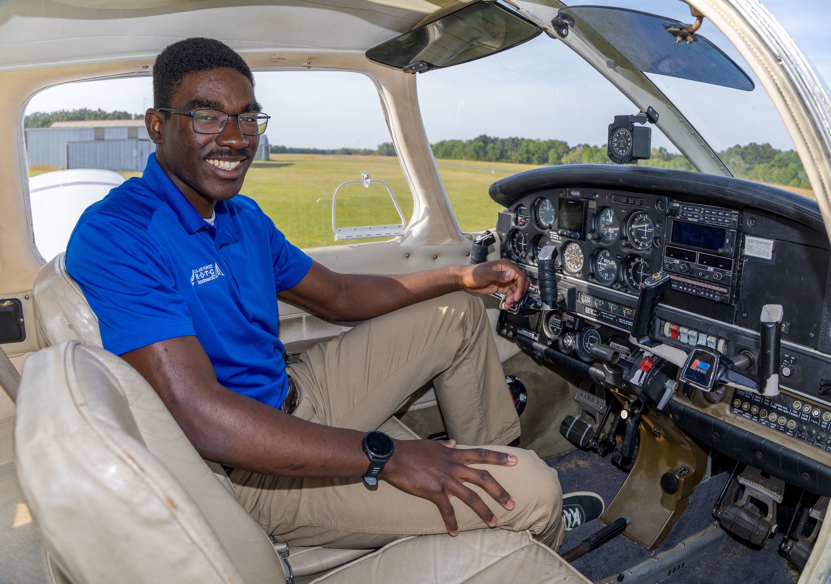 Cadet Maximus Lang sits in the cockpit of a Piper Warrior aircraft during flight training.
