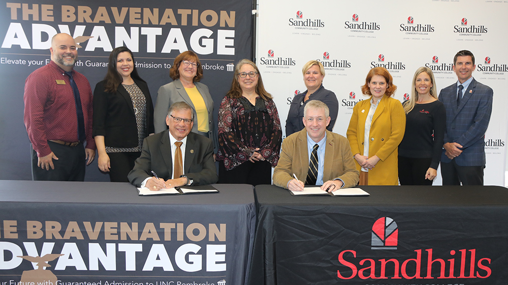 UNCP and Sandhills CC at table for signing of an MoU