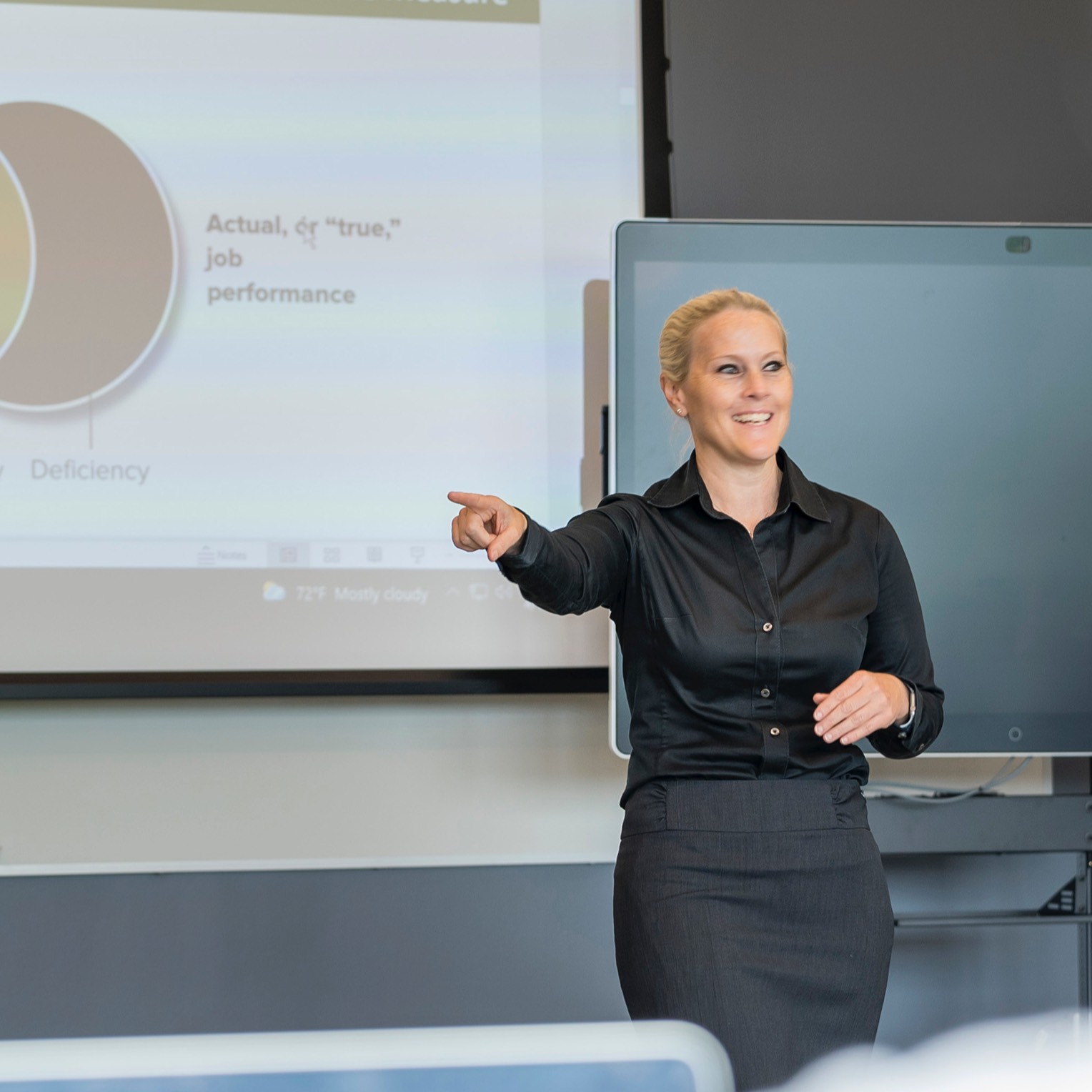 business management faculty member standing in front of a classroom, UNC Pembroke campus