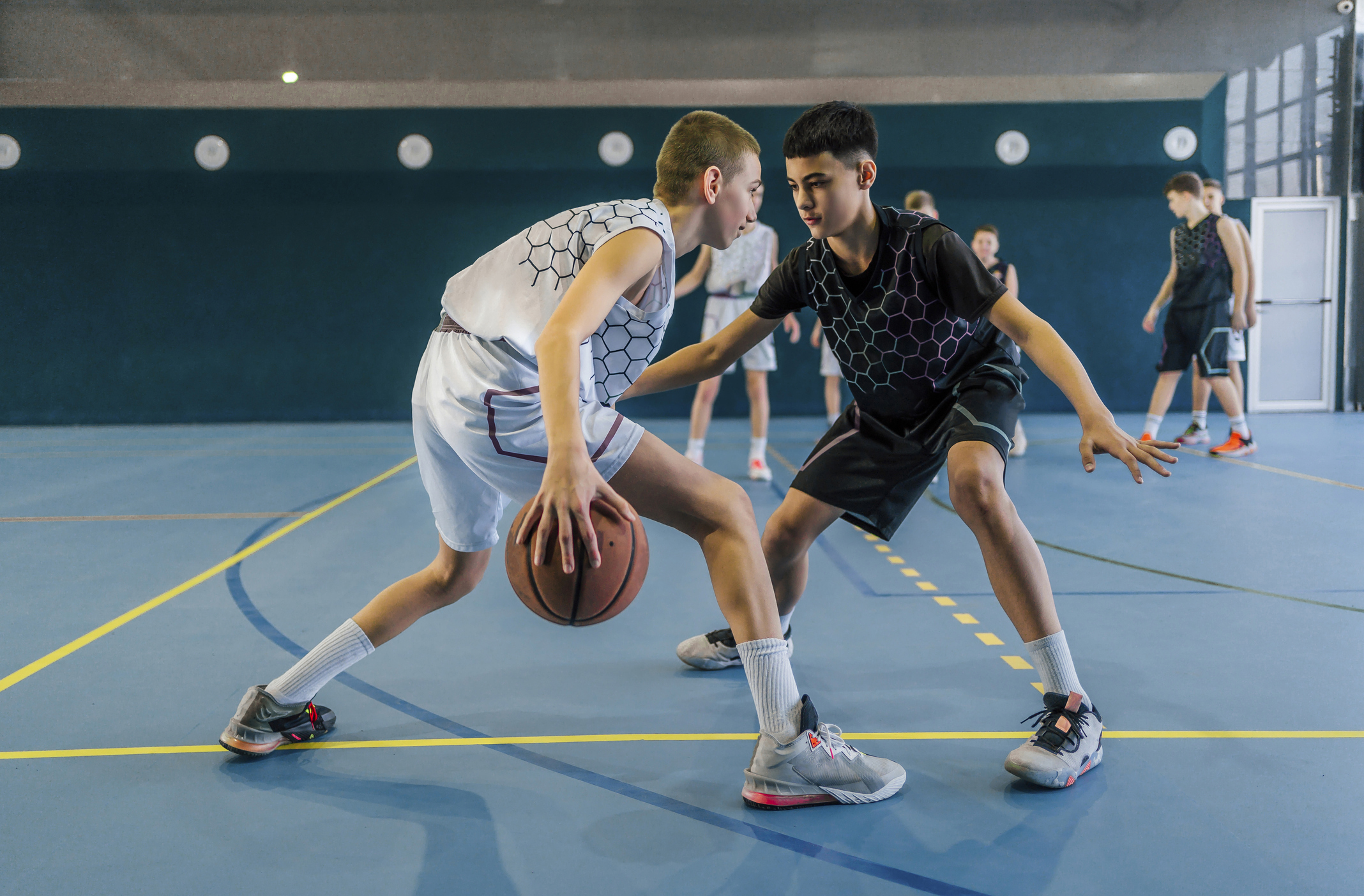 teens learning about how to play basketball