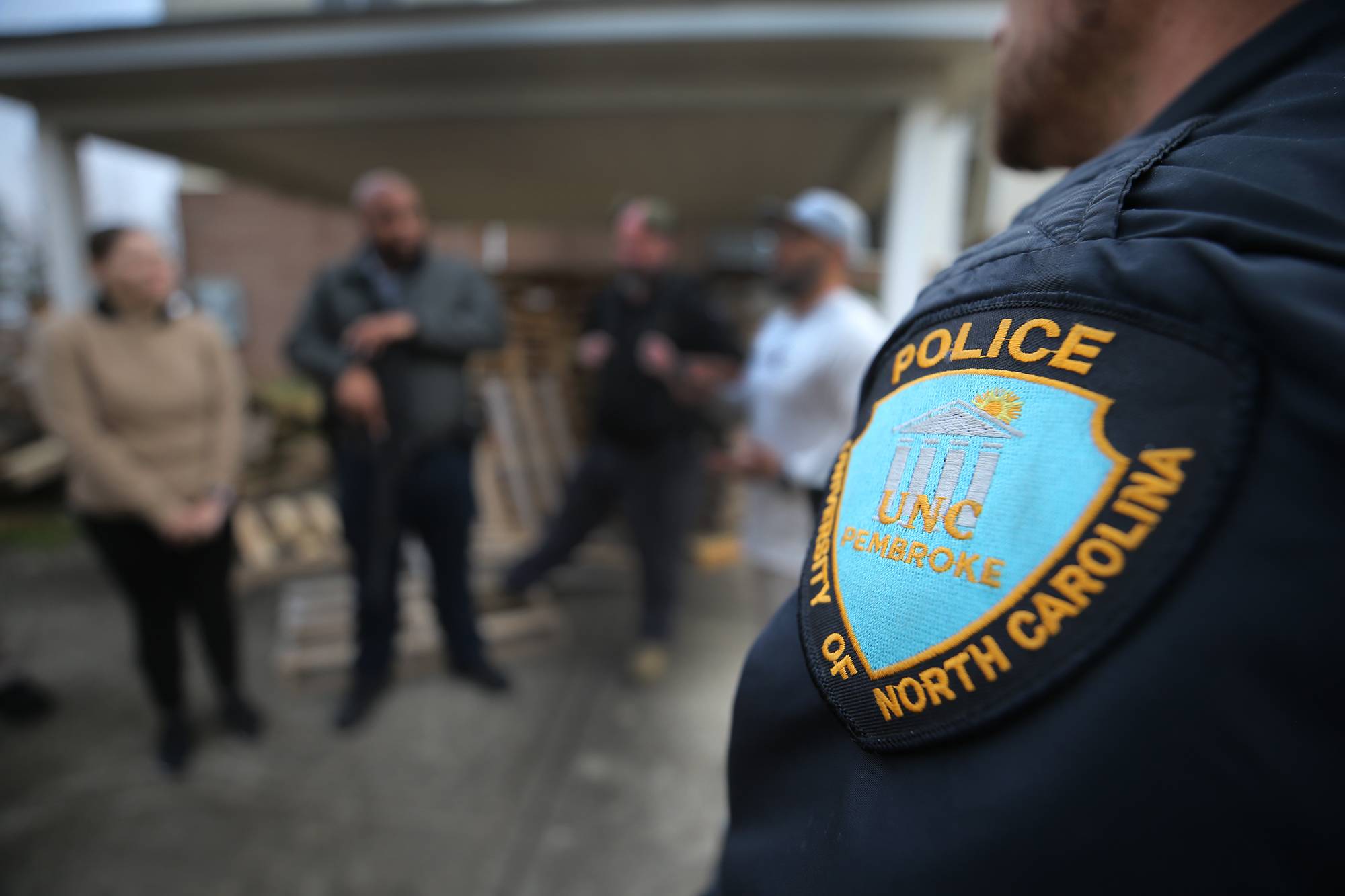 UNCP campus police badge on the shoulder of an officer