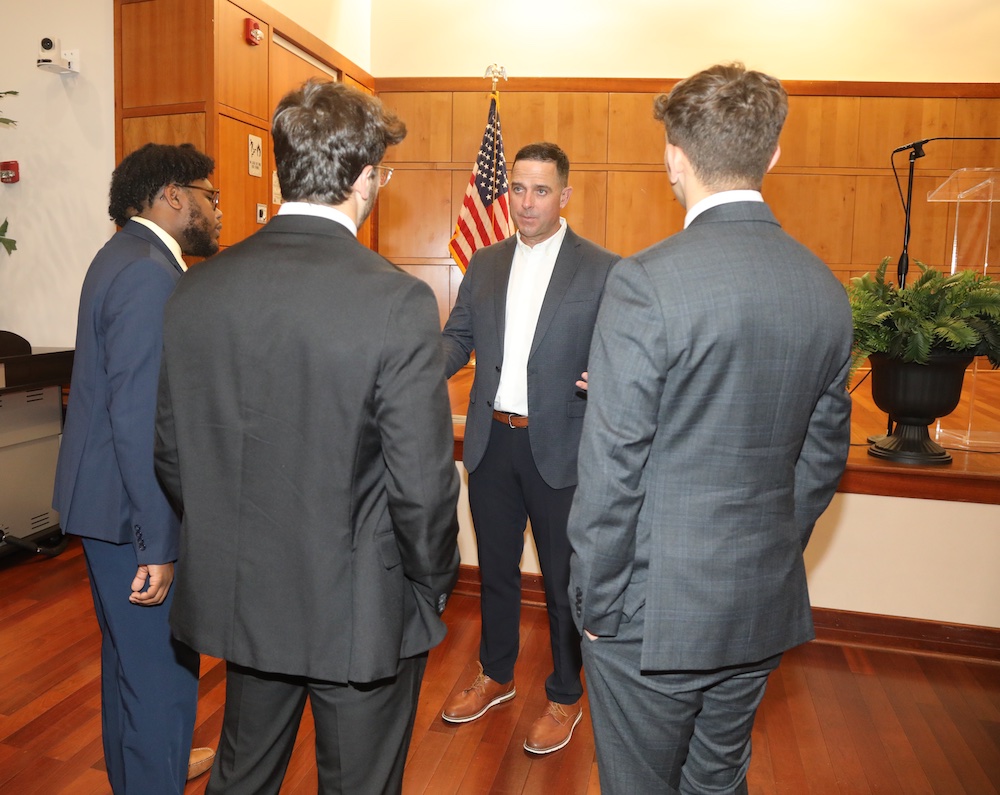 Col. Chad Mixon speaks with students