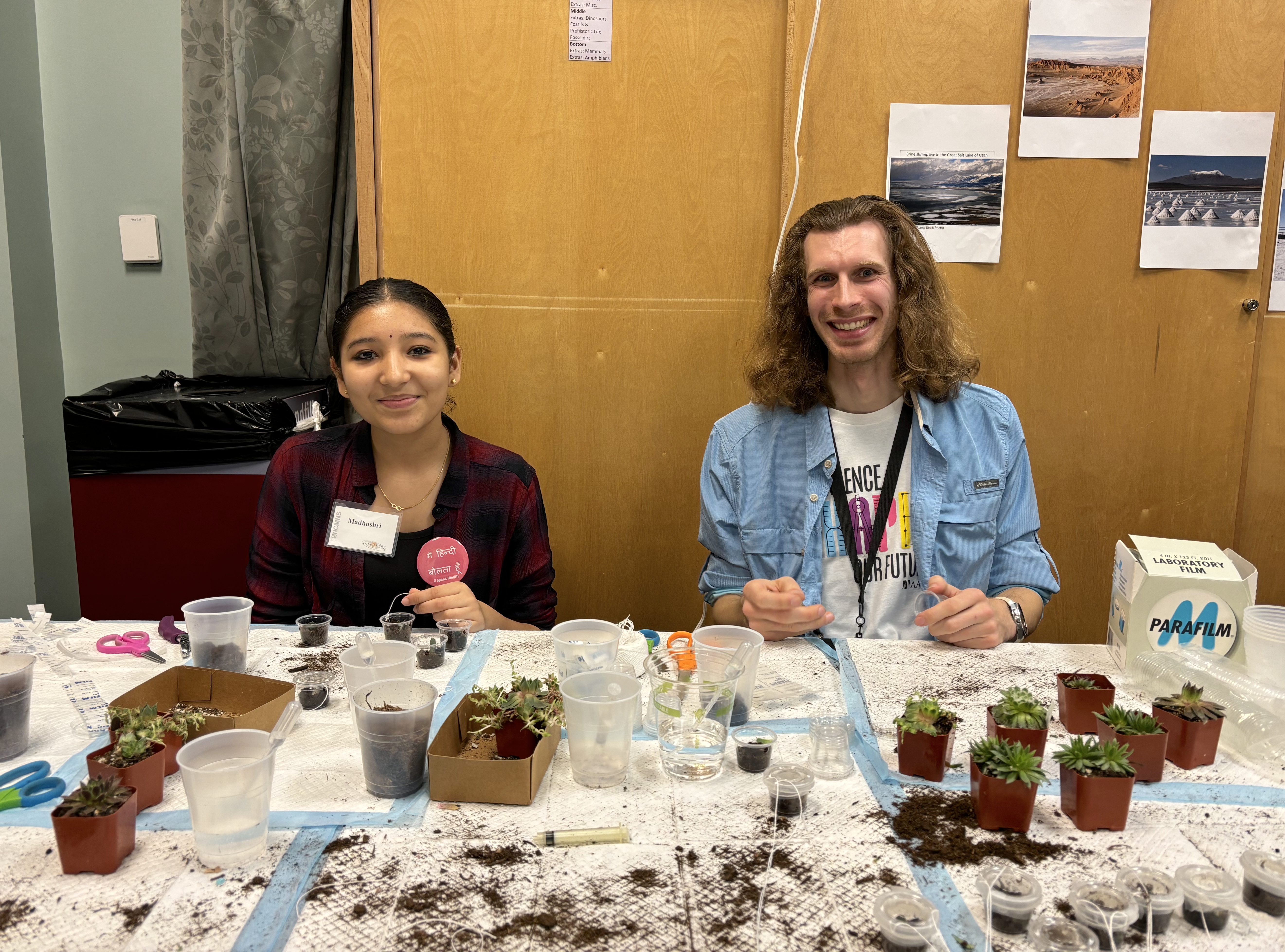 Two college students smile while working a NCAS table