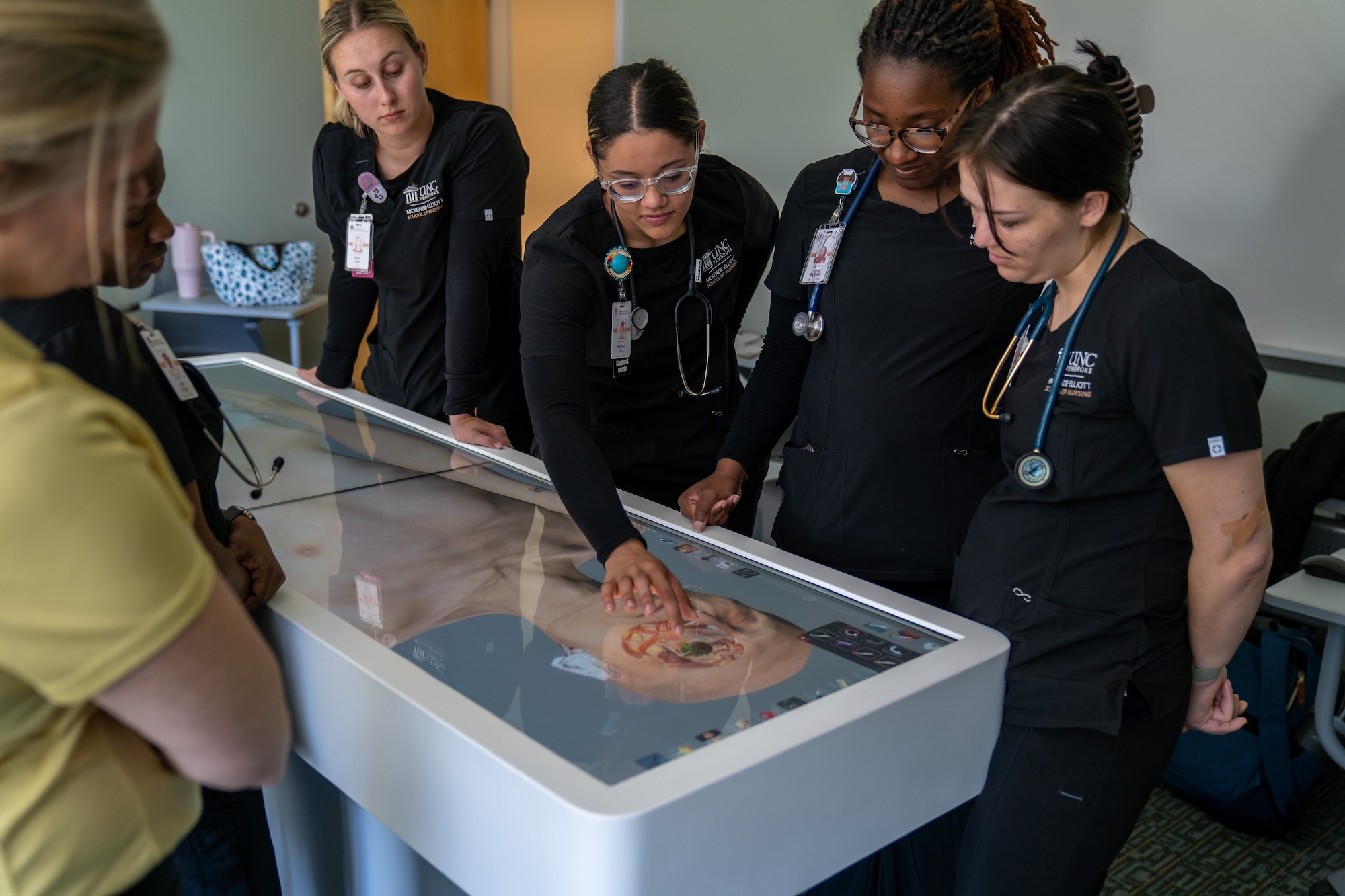 UNCP nursing students looking at the anatomy table