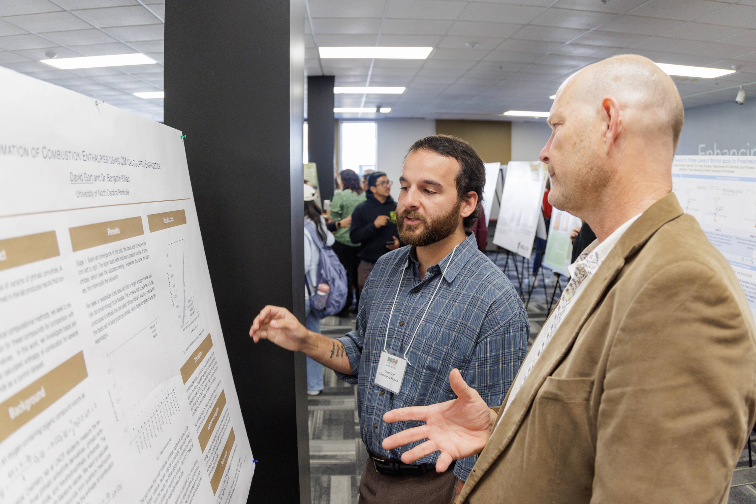 David Gort engages with professor Dr. Robert Poage during the 19th annual PURC Symposium.