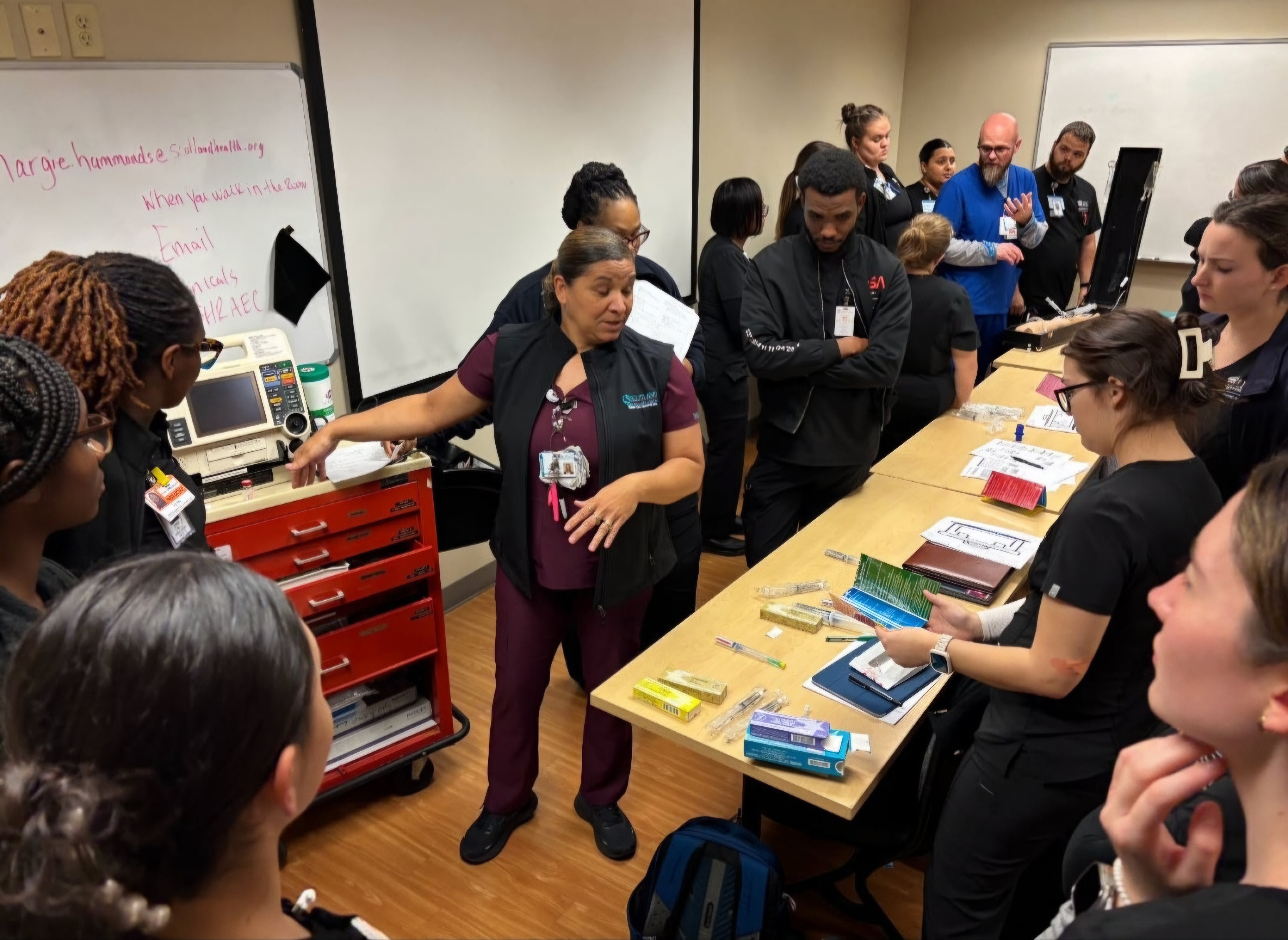 An instructor leads a class of nursing students.