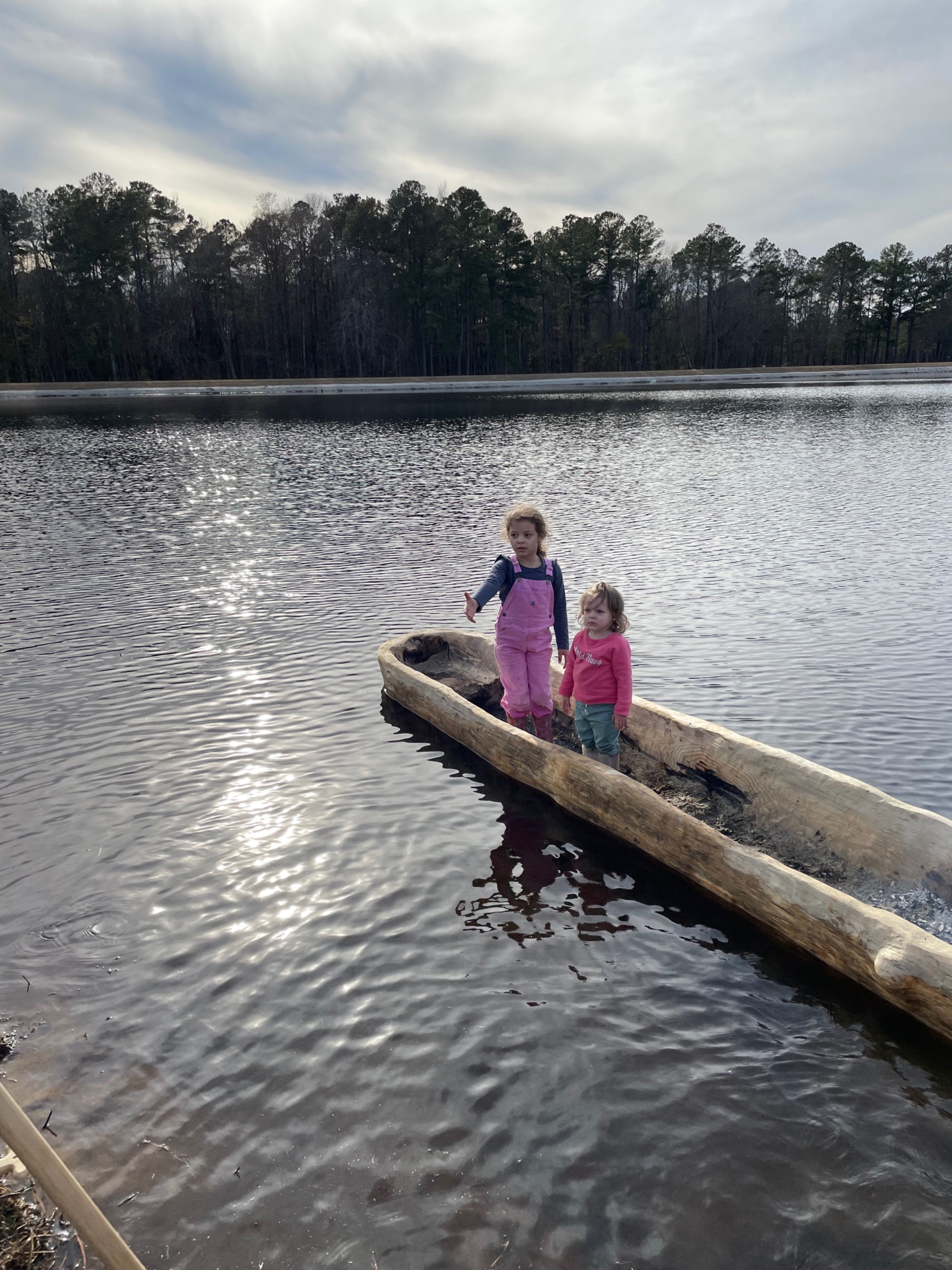 Children stand in the canoe
