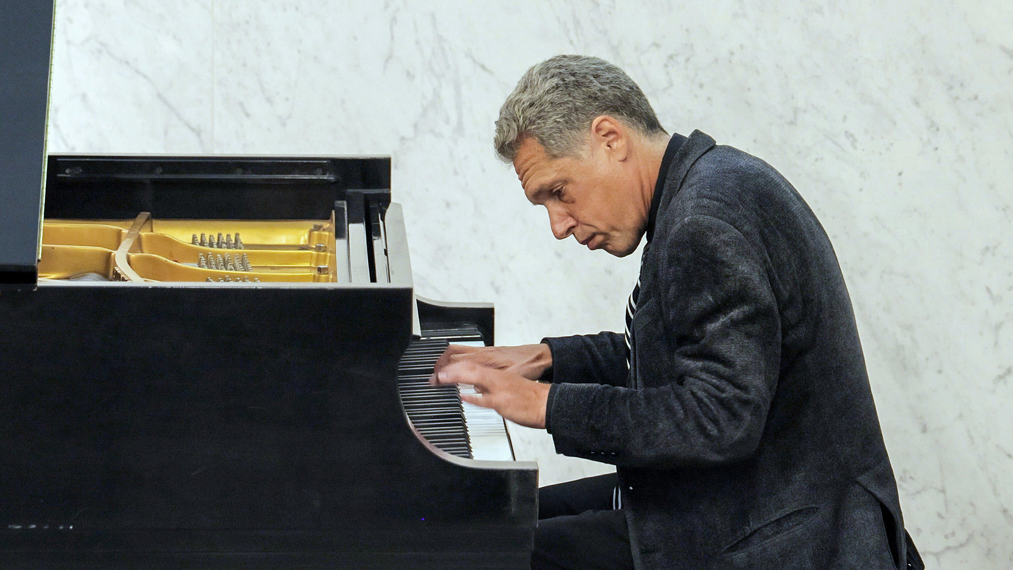 Composer and concert pianist Seith Weinstein playing the piano