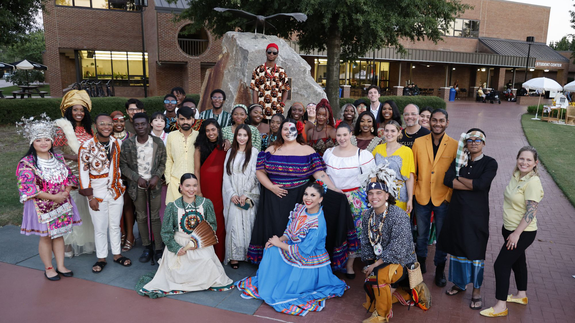 All participants of the UNCP Office of Global Engagement cultural fashion show pose together for a group photo.