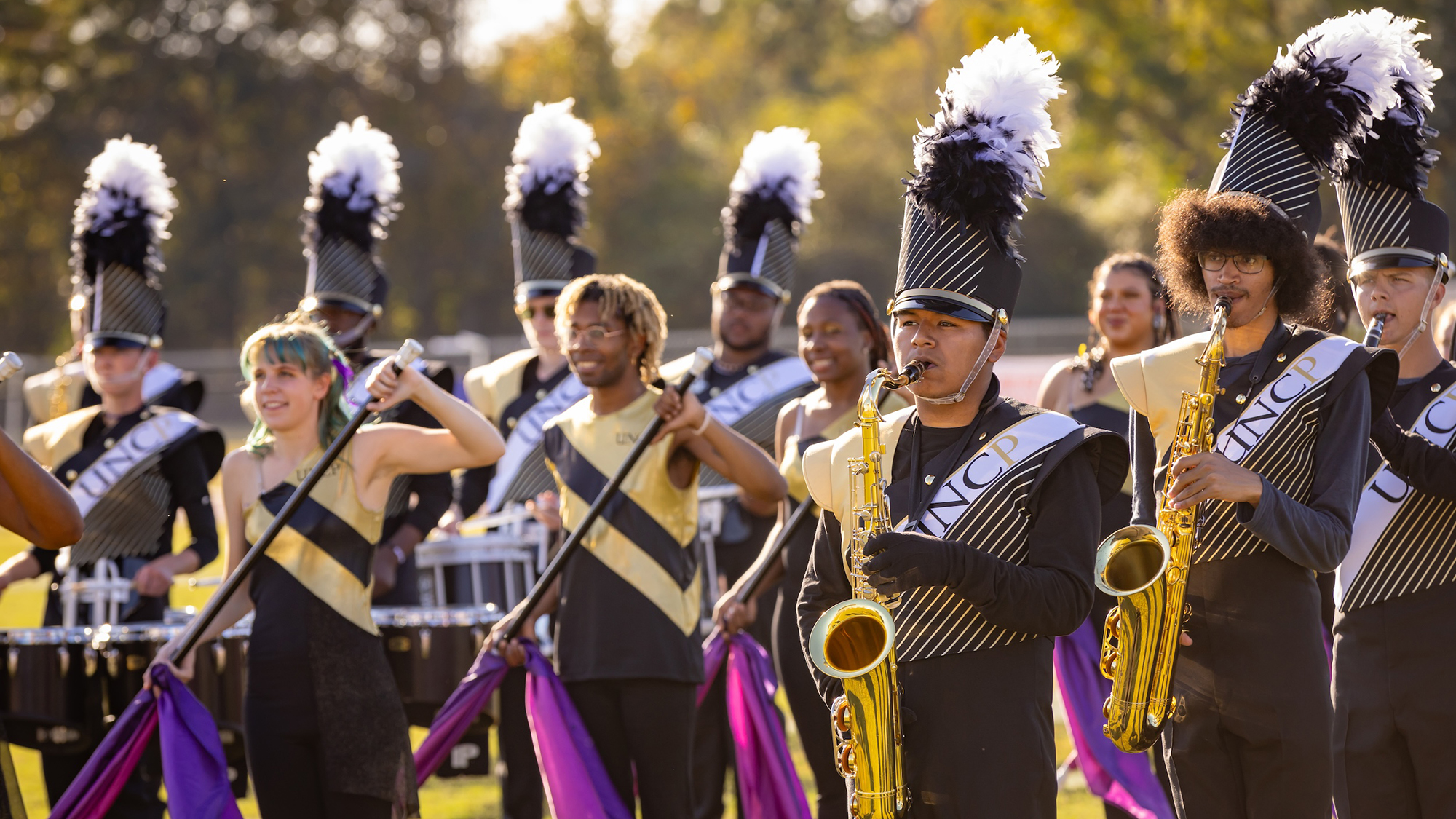 front row of the "Spirit of the Carolinas" Marching Band playing instruments