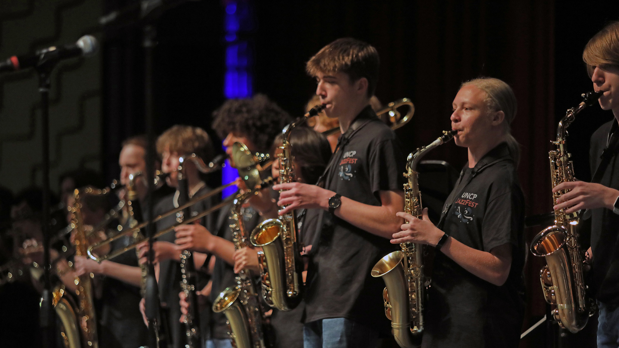 line of student jazz musicians playing alto saxes